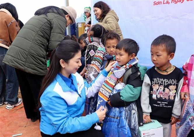 Tặng áo ấm, khăn ấm, hộp đựng cơm cho học sinh tại điểm trường Tảo Ván, Trường phổ thông Dân tộc bán trú Tiểu học Chiềng Công, xã Chiềng Công, huyện Mường La. Ảnh: TTXVN phát potal-son-la-to-chuc-khanh-thanh-cong-trinh-truong-dep-cho-em-7791086.jpg