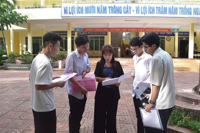 Cô Đinh Châu Thể Ngọc, giáo viên môn Toán Trường THPT DTNT Nơ Trang Lơng (thành phố Buôn Ma Thuột, Đắk Lắk) trao đổi với các thí sinh trong kỳ thi tốt nghiệp Trung học Phổ thông năm 2024. Ảnh: Nguyên Dung – TTXVN potal-thi-tot-nghiep-thpt-nam-2024-thi-sinh-hoan-thanh-bai-thi-mon-toan-7453084.jpg
