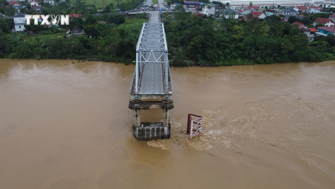 Cầu Phong Châu (Phú Thọ) bị sập, sáng 9/9. Một trụ và hai nhịp của cây cầu đã bị nước lũ cuốn. Ảnh: Tạ Toàn - TTXVN vna_potal_sap_cau_phong_chau_tai_phu_tho__7582402.jpg