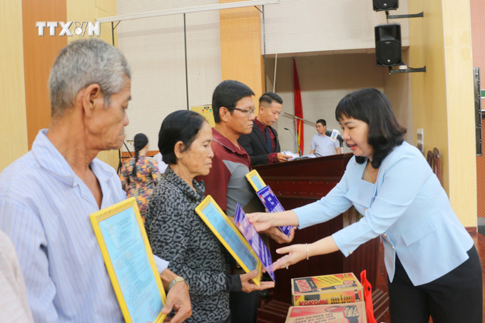 Bà Thi Hồng Thúy, Phó Bí thư Thường trực Huyện ủy Châu Phú trao biểu trưng tặng nhà "Đại đoàn kết" và quà cho các hộ dân. Ảnh: Công Mạo-TTXVN vna_potal_an_giang_ban_giao_145_can_nha_dai_doan_ket_cho_ho_ngheo_kho_khan_ve_nha_o_7725974.jpg
