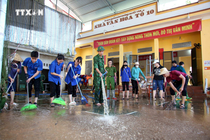 Lực lượng Công an, bộ đội và đoàn viên thanh niên hỗ trợ người dân thành phố Sơn La khắc phục hậu quả mưa lũ. Ảnh: Quang Quyết – TTXVN vna_potal_son_la_ung_pho_khan_cap_voi_nguy_co_mua_lon_tiep_tuc_tren_dien_rong_7505868.jpg