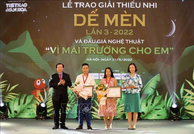 Tổng Giám đốc TTXVN Vũ Việt Trang và Thứ trưởng Bộ Văn hóa, Thể thao và Du lịch Tạ Quang Đông trao giải Khát vọng Dế Mèn cho tác giả Nguyễn Hoàng Diệu Thủy (phải) với truyện dài "Đu đưa trên ngọn cây bàng" và tác giả Phạm Huy Thông với tác phẩm "Cơ bản là