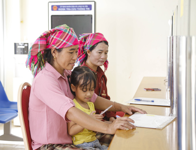 Đồng bào dân tộc Hà Nhì làm thủ tục tại Trung tâm phục vụ hành chính công xã biên giới Sín Thầu, tỉnh Điện Biên. Ảnh: Trung Kiên/TTXVN sin-man-2107.jpg