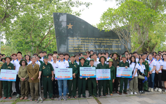 Đoàn thanh niên, sinh viên kiều bào tặng quà trị giá 100 triệu đồng cho các cựu chiến bình và thanh niên xung phong. Ảnh: Tường Vi/TTXVN quang-tri3-2107.jpg