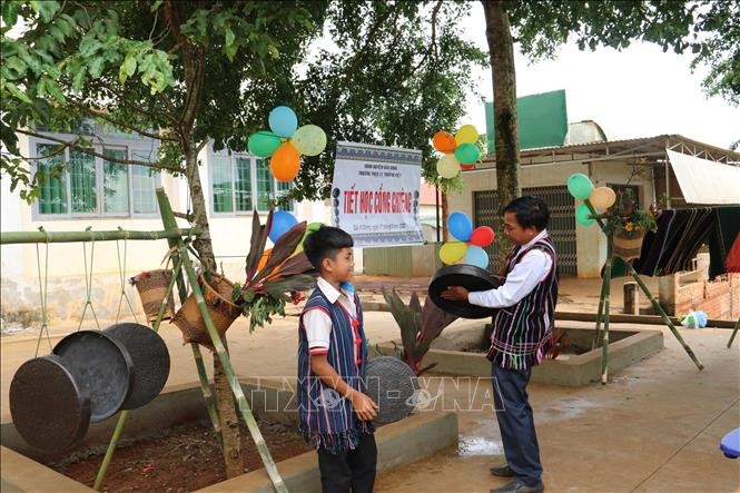 Học sinh được trải nghiệm tập đánh chiêng tại tiết học. Ảnh: TTXVN phát