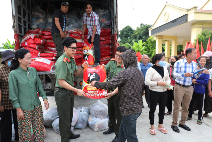 Cán bộ, chiến sĩ phòng Tham mưu Công an tỉnh Tuyên Quang và thành viên Hội thiện nguyện “Từ tâm Thới Lai” - Thành phố Cần Thơ trao gạo cho người dân vùng lũ. tuyen-quang-271025.jpg