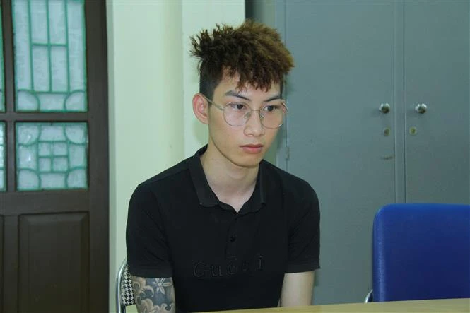 Đối tượng Vũ Minh Toàn tại cơ quan công an. Ảnh: TTXVN phát