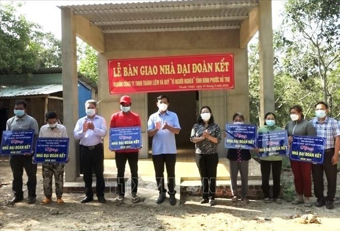 Người nghèo nhận giấy chứng nhận trao nhà. Ảnh: TTXVN phát.