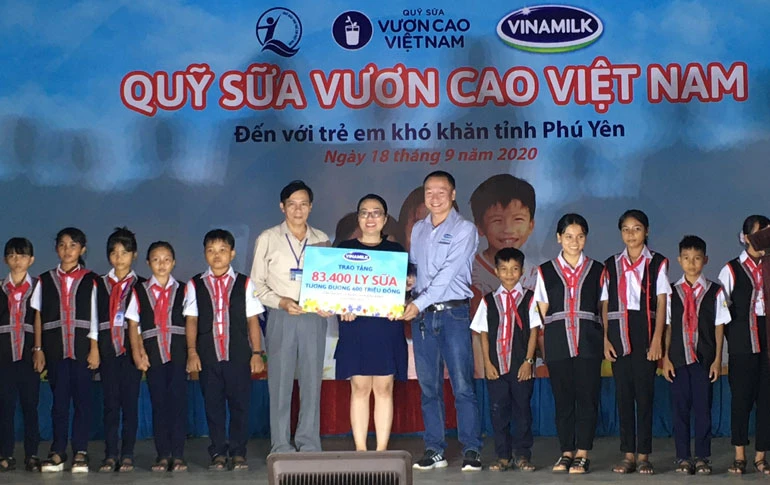 Đại diện Sở Lao động, Thương binh và Xã hội tỉnh Phú Yên, Công ty Cổ phần sữa Việt Nam (Vinamilk) trao bảng tượng trưng 83.400 li sữa cho trẻ em nghèo tỉnh Phú Yên. Ảnh: Phạm Cường-TTXVN