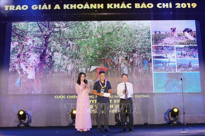 Ông Nguyễn Đức Lợi, Ủy viên Trung ương Đảng, Tổng Giám đốc TTXVN trao giải A cho tác giả Tất Sơn (Báo Ảnh Việt Nam - TTXVN) đoạt giải. Ảnh: Thành Đạt - TTXVN