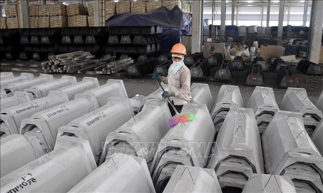 Công ty TNHH Đầu tư và Xây dựng Thành Hưng đang sản xuất cấu kiện kênh mương bằng bê tông đúc sẵn để cung cấp cho các địa phương. Ảnh: Quang Đán – TTXVN