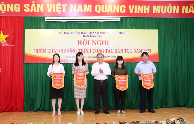 Ông Huỳnh Văn Hồng Ngọc (giữa), Trưởng Ban Dân tộc Thành phố Hồ Chí Minh trao cờ Cụm trưởng cụm thi đua năm 2023 cho đại diện các đơn vị. Ảnh: Xuân Khu-TTXVN Triển khai công tác dân tộc phù hợp với tình hình thực tế địa phương ảnh 2