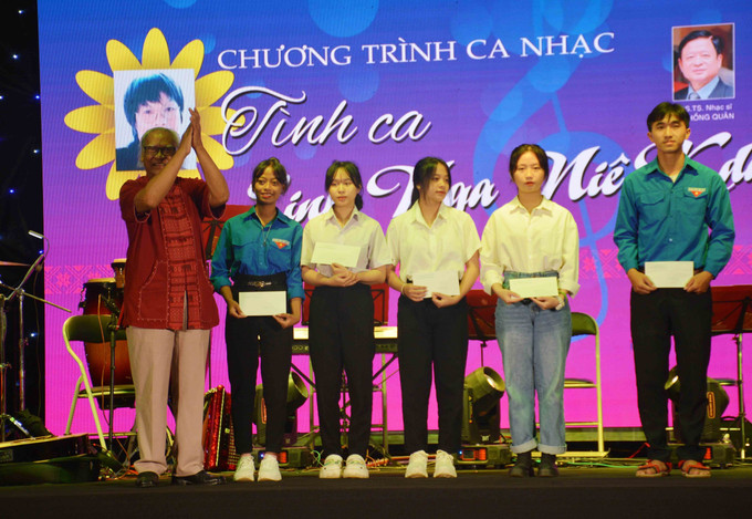 Gia đình nhạc sĩ Linh Nga Niê Kdăm tặng 5 phần quà cho sinh viên có hoàn cảnh khó khăn đang học trường Cao đẳng Văn hóa Nghệ thuật Đắk Lắk. Ảnh: Hoài Thu – TTXVN Nồng nàn tình ca Linh Nga Niê Kdăm ảnh 6
