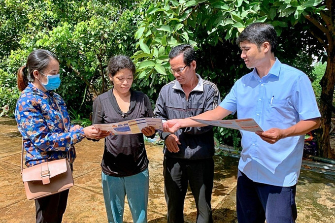 Cán bộ bảo hiểm xã hội huyện Ia Grai tuyên truyền chính sách và vận động người dân tham gia bảo hiểm y tế. Ảnh: TTXVN phát Gia Lai: Đồng hành vì sức khỏe người nghèo ảnh 3