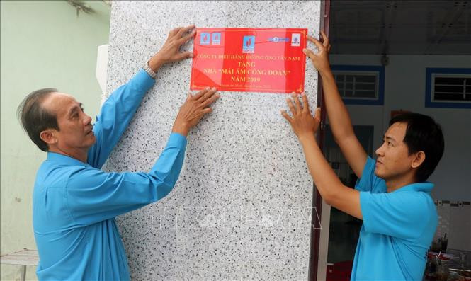 Lãnh đạo Liên đoàn Lao động tỉnh Kiên Giang gắn bảng “Mái ấm Công đoàn” nhà thầy Phan Thanh Tân, đoàn viên công đoàn cơ sở Trường Tiểu học Thuận Hòa 3. Ảnh: Lê Huy Hải - TTXVN Hỗ trợ “Mái ấm Công đoàn” cho đoàn viên khó khăn ảnh 3