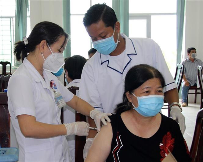 Tiêm ngừa vaccine phòng COVID-19 cho các đối tượng được ưu tiên. Ảnh: TTXVN phát Chuyển COVID-19 sang “bệnh nhóm B” – Nhiều câu hỏi bỏ ngỏ ảnh 3