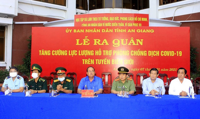 Ông Nguyễn Thanh Bình, Chủ tịch UBND tỉnh An Giang (người ngồi giữa) tại buổi Lễ ra quân chống COVID- 19 trên tuyến biên giới. Nguồn :baodantoc.vn Dịch COVID-19: An Giang hỗ trợ người Khmer nghèo gốc Việt ở Campuchia phòng, chống dịch ảnh 1