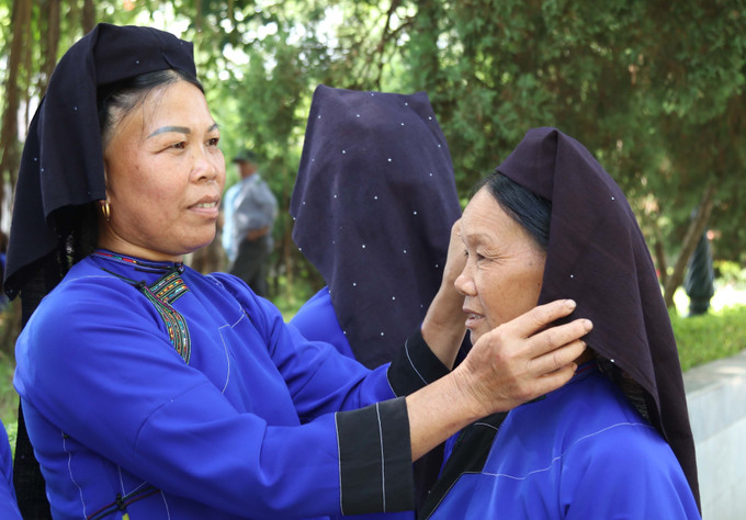 Đồng bào dân tộc Nùng Lạng Sơn chỉnh sửa trang phục đi chơi Tết Độc lập. Ảnh: Quang Duy – TTXVN Bảo tồn, phát huy giá trị văn hóa truyền thống của các tộc người ảnh 1