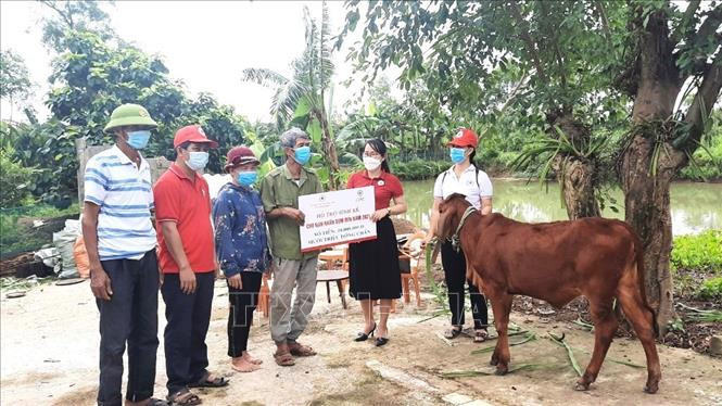 Các hộ dân được hỗ trợ sinh kế vui mừng, phấn khởi khi được trao hỗ trợ sinh kế từ lãnh đạo Hội Chữ thập đỏ tỉnh Quảng Bình. Ảnh: Võ Dung -TTXVN Quảng Bình hỗ trợ sinh kế, phát triển sản xuất cho nạn nhân bom mìn năm 2021 ảnh 1