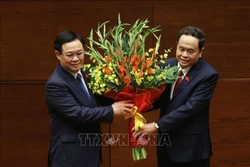 Phó Chủ tịch Thường trực Quốc hội khóa XIV Trần Thanh Mẫn tặng hoa chúc mừng Chủ tịch Quốc hội Vương Đình Huệ. Ảnh: Dương Giang-TTXVN