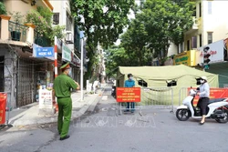 Lực lượng công an hướng dẫn người dân không vào khu vực bị phong toả. Ảnh: Hoàng Hiếu - TTXVN
