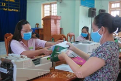 Người dân phường Quyết Thắng, thành phố Kon Tum làm thủ tục nhận tiền vay vốn tín dụng chính sách. Ảnh: Dư Toán – TTXVN