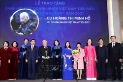 Phó Chủ tịch nước Võ Thị Ánh Xuân và Trưởng Ban Dân vận Trung ương Bùi Thị Minh Hoài trao Cúp và hoa cho đại diện gia đình cụ Hoàng Thị Minh Hồ. Ảnh: Trọng Đức - TTXVN 