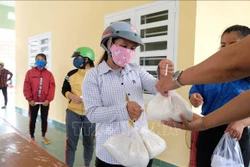 Cấp gạo cho người dân huyện Khánh Vĩnh, huyện miền núi có gần 15.000 người thiếu đói . Ảnh: Nguyễn Dũng – TTXVN