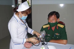 Cán bộ, chiến sĩ, nhân viên Bộ CHQS tỉnh Bạc Liêu khai phiếu và khám sàng lọc tại Bệnh viện 121 trước khi tiêm vaccine phòng COVID-19. Ảnh: Chanh Đa-TTXVN .