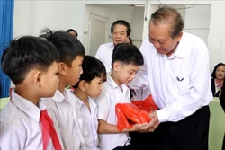 Phó Thủ tướng Thường trực Trương Hòa Bình trao tặng quà cho các trẻ khuyết tật. Ảnh: Lê Ngọc Phước - TTXVN