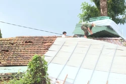 Chính quyền địa phương hỗ trợ người dân sửa lại các mái nhà bị hư hỏng. Ảnh: TTXVN phát