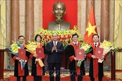 Chủ tịch nước Nguyễn Xuân Phúc trao quyết định và tặng hoa chúc mừng 4 Thẩm phán Tòa án nhân dân tối cao. Ảnh: Thống Nhất – TTXVN