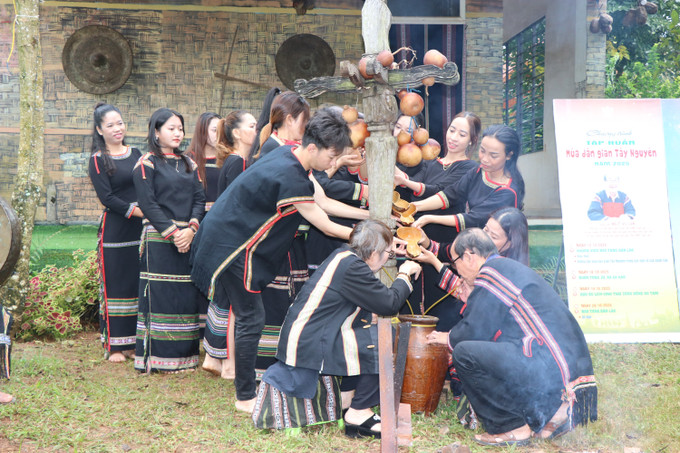 Các bạn trẻ thực hiện nghi thức “Mời rượu” một hoạt động mang tính trang trọng trong nghi lễ đón khách của dân tộc Ê Đê.