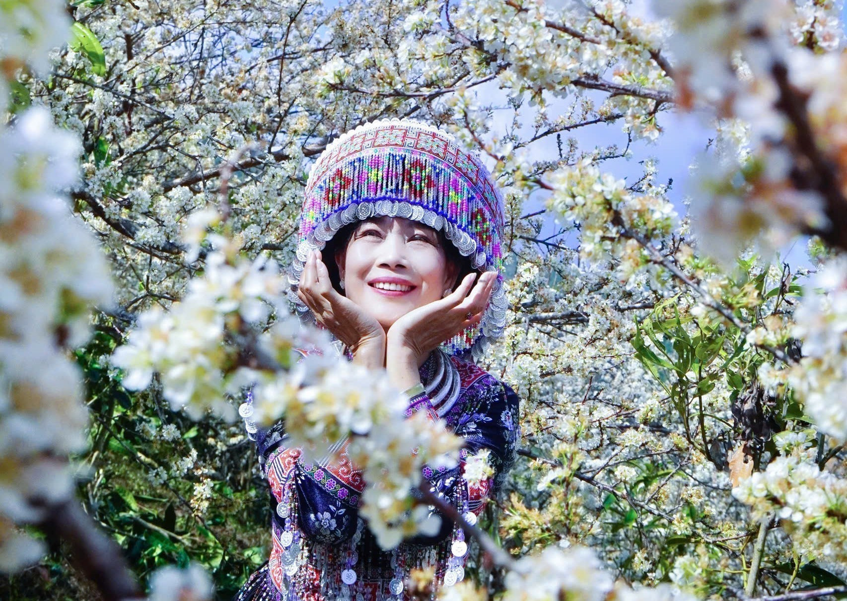 Được "hóa thân" vào cô gái Mông, du khách đến từ Hà Nội lưu giữ hình ảnh đẹp bên vườn mận ở vùng cao Púng Luông, Mù Cang Chải. Ảnh: Đinh Thùy/TTXVN