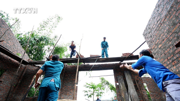 Lực lượng Dân quân tự vệ và Đoàn Thanh niên xã Nà Hẩu (Văn Yên, Yên Bái) giúp đỡ xây dựng nhà cho hộ nghèo. Ảnh: TTXVN phát vna_potal_no_luc_xoa_nha_tam_cho_ho_ngheo_o_vung_cao_yen_bai__7559430.jpg