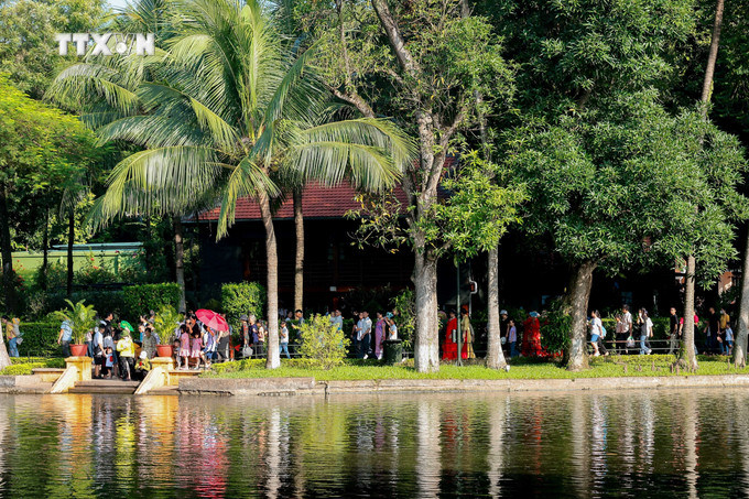 Người dân tham quan Nhà sàn trong Khu di tích Chủ tịch Hồ Chí Minh. Ảnh: Hoàng Hiếu - TTXVN vna_potal_hang_van_nguoi_vao_lang_vieng_chu_tich_ho_chi_minh_dip_79_nam_quoc_khanh_7569310.jpg