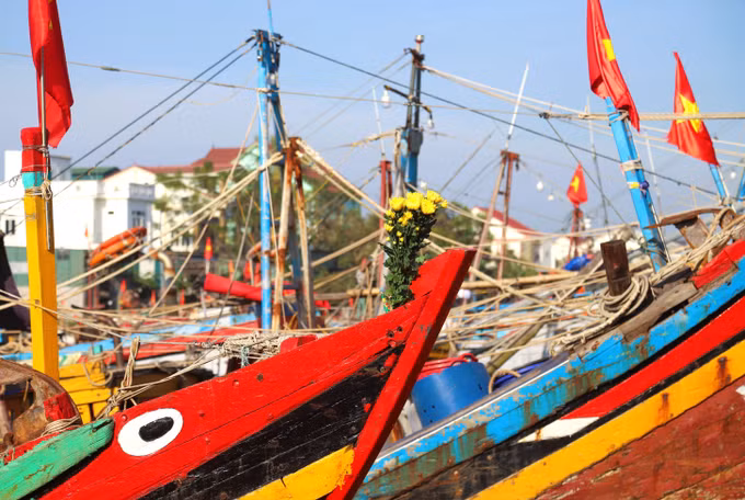 Sau lễ "cúng thuyền", trên những mũi tàu, thuyền đều được cắm những bó hoa cúc vàng và những nén nhang thơm. Ảnh: Xuân Tiến/TTXVN